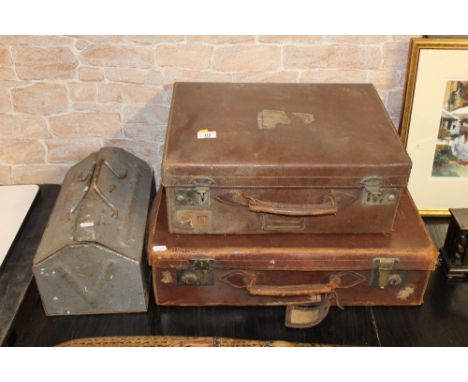 Two brown leather suitcases and a metal toolbox containing a small selection of hand tools. (all items with some damage).