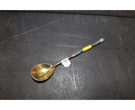 A Russian silver gilt and champleve enamel spoon, 13.5 cm long with 84 standard kokoschnik mark