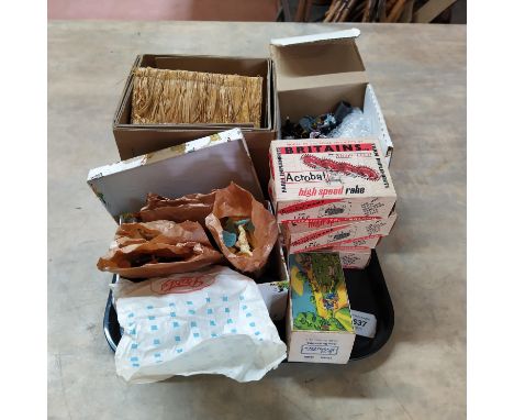 A scarce Britains farm thatched cottage building together with a box of vintage lead Britains farm animals, a model cultivato