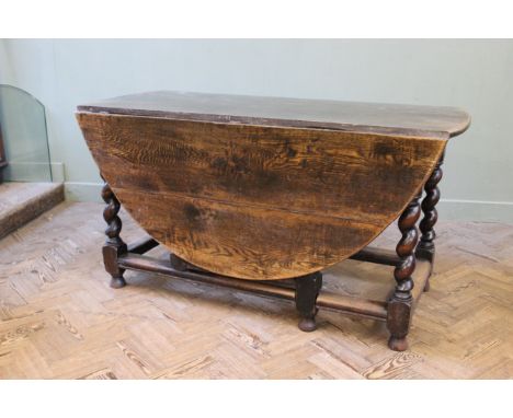 An early 19th Century carved oak gate leg dining table, width 56" x depth 65" x height 29"