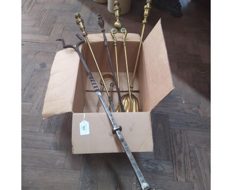A selection of brass fire irons plus a large cast iron two prong fork marked G G Hayman Perranporth