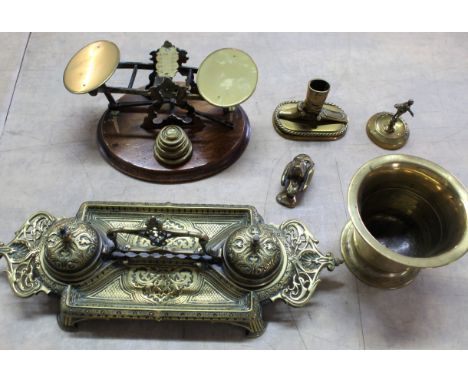 A mixed lot including a Victorian brass double inkwell with ceramic liners, brass postal scales with weights (as found), a mo
