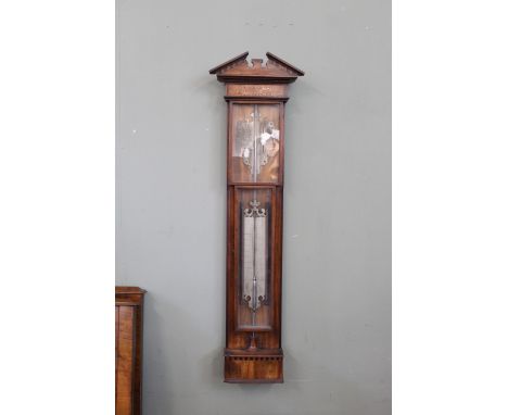 A late 18th Century mahogany barometer by P Wast En Zoon, Amsterdam, two hinged doors enclosing pewter scales and brass trend