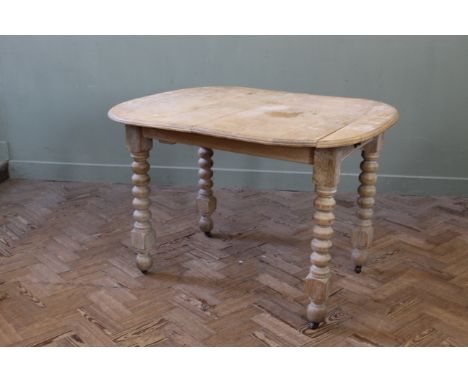 A late 19th Century limed oak bobbin leg dining table, width 39" x depth 35" x height 28"