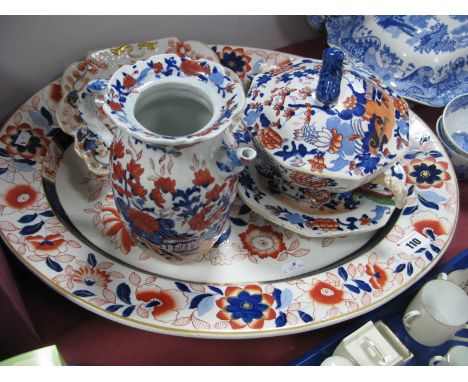 An Ashworth Ironstone Imari Meat Plate, with well; a similar sauce tureen, cover and stand and a shaped dish and jug. (4)