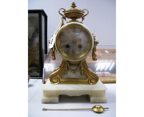 A French Eight Day Mantel Clock, circa 1900, with gong strike, gilt Roman numerals, lion mask handles and vase finial to onyx