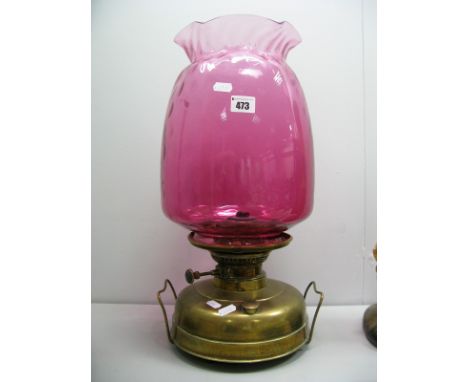 A XIX Century Brass Oil Lamp, with cranberry glass shade.