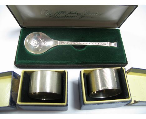 The 1976 John Pinches Christmas Spoon, in silver by Peter Jackson  (cased), pair of silver napkin rings, engine turned and en