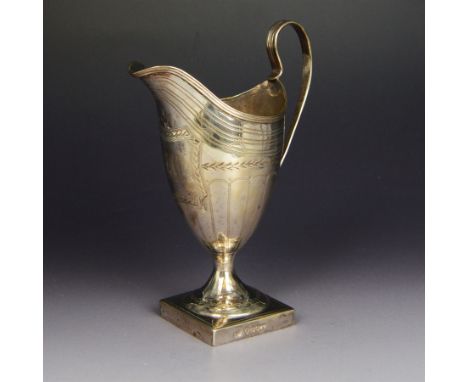 George III silver helmet shaped jug, with engraved decoration and monogram to body, with C scroll handle and upon square base