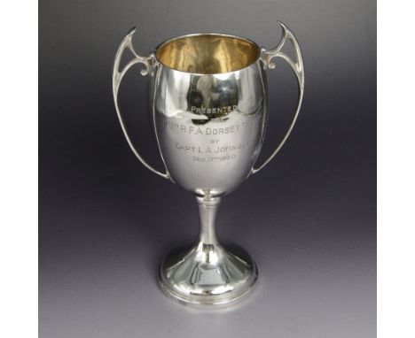 1930s silver twin handled trophy cup, with Art Nouveau style handled and presentation engraving to body, upon domed circular 
