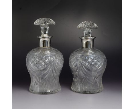 Pair of 1930s cut glass decanters, each with silver collars, hallmarked Mappin & Webb Ltd, London 1939, H22.5cm