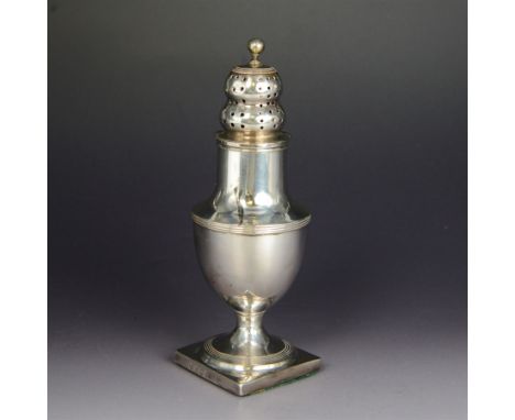 George III silver sugar caster of waisted urn form, the pierced removable cover with bun finial, upon a weighted square base,