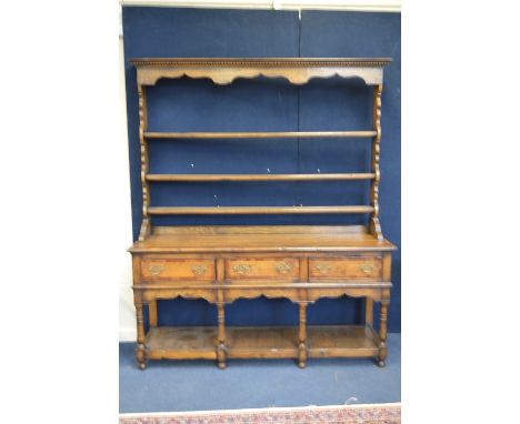 A RECENT OAK AND MAHOGANY CROSSBANDED DRESSER, the three tier plate rack above a three drawer base with lower shelf, approxim