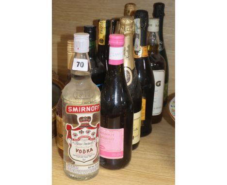 Eleven assorted bottles including Vodka, Champagne and whisky.