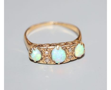 An early 20th century, 18ct gold, three stone white opal and diamond chip set ring, chip to central stone, size R.