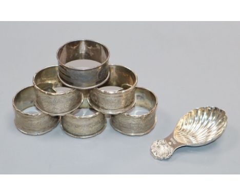 A set of five George V silver serviette rings, one other and a modern silver caddy spoon.