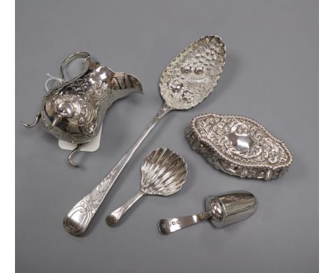 A George III embossed silver cream jug, London 1770, a George III shell-bowl caddy spoon and three other items, a George III 