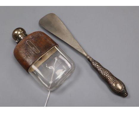 A silver mounted leather covered glass spirit flask and a silver handled shoe horn.