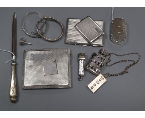 Two silver engine-turned cigarette cases, a similar vesta case, a silver-gilt snuff box and sundries, comprising an engraved 