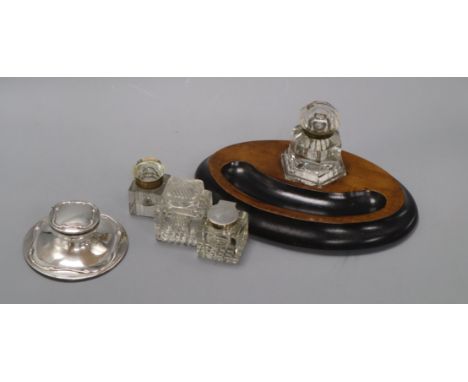 A silver capstan inkwell and four other inkwells (5)