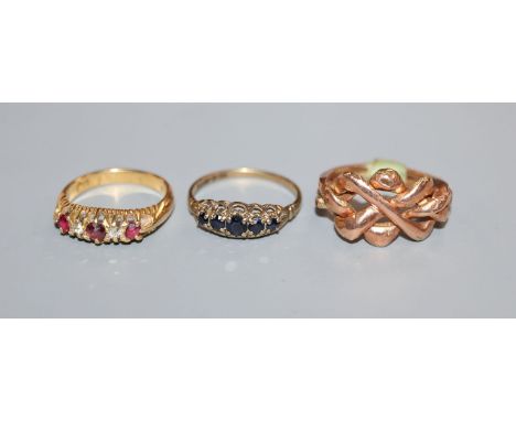 An Eastern rose yellow metal puzzle ring (tests as 14ct), an 18ct gold, ruby and diamond half-hoop ring and a sapphire half-h