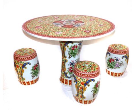 A Chinese circular ceramic table, together with three matching barrel stools. (4)