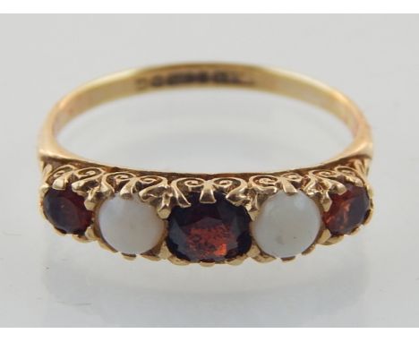 A 9ct yellow gold, garnet and opal five stone ring. 