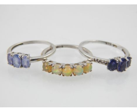 A 9ct white gold and five stone opal ring, together with a two other three stone 9ct white gold rings. 