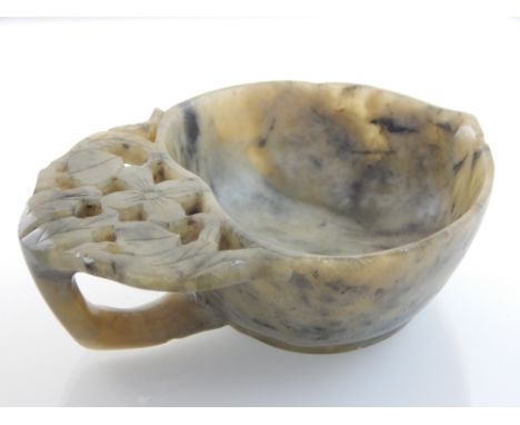 A Chinese mottled green jade brush water cup, in the form of a pomegranate with leaf for handle. L. 9cm