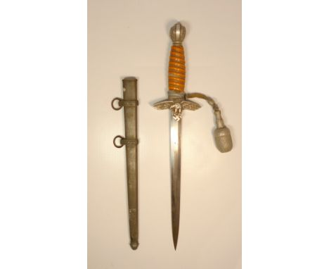 A German Luftwaffe dagger, 3rd Reich ceremonial dagger, scabbard and sword knot, swastika finial, wine bound amber grip, eagl