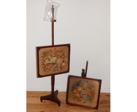 A pair of William IV mahogany pole screens, with polychrome tapestry banners, on turned columns and triangular platform bases
