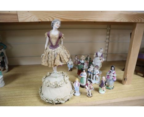 A Continental jointed porcelain figure of a ballerina on stand, a late Meissen figure of a dancer and ten other figures, tall