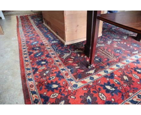 A North West Persian style red and blue ground carpet, 300 x 190cm