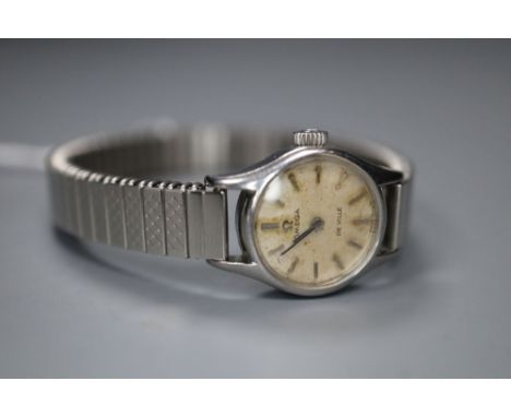 A lady's stainless steel Omega De Ville manual wind wrist watch, on associated strap.CONDITION: Dial dirty and stained. Minor