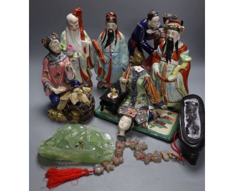 Three Chinese enamelled porcelain figures of immortals, tallest 24cm, three Shiwan type pottery groups, an agate necklace and