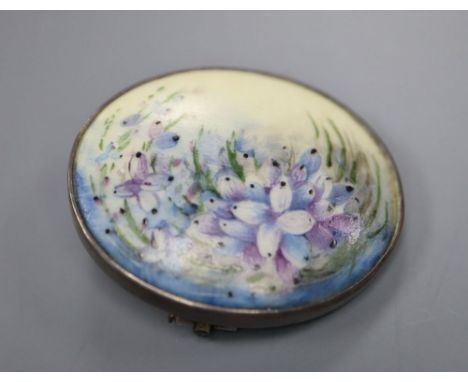 An early 20th century sterling and porcelain oval brooch, decorated with flowers, 31mm.
