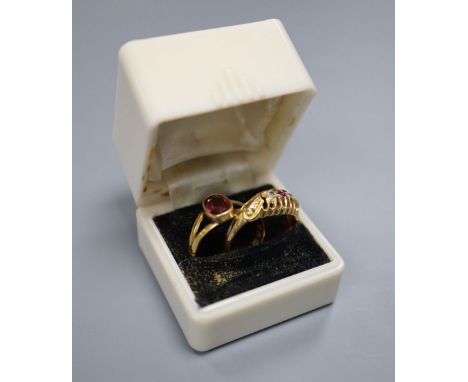 A late Victorian 22ct gold and solitaire garnet set ring, size O (adapted?), gross 2.5 grams and an Edwardian 18ct gold, ruby