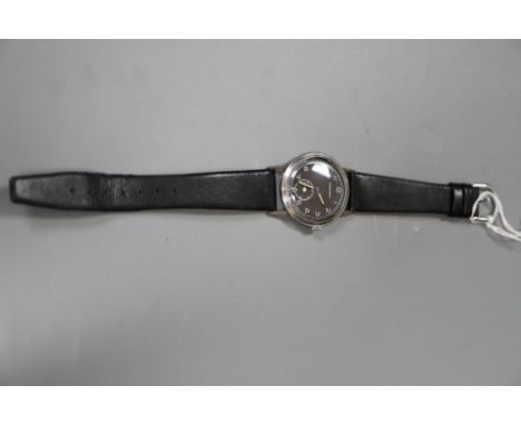 A gentleman's 1940's steel Longines black dial manual wind wrist watch, case diameter 34mm, on associated strap.CONDITION: Sc