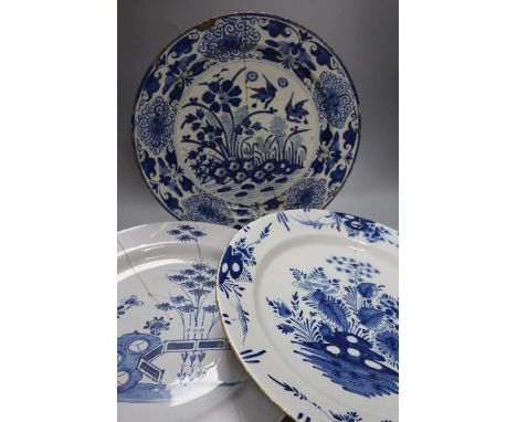Two 18th century Delft blue and white dishes and a similar English delftware dish, 34-35cm, all a.f.