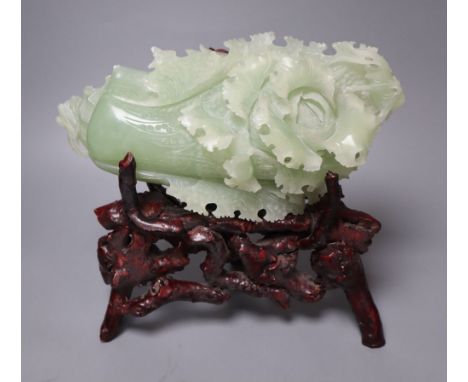 A Chinese bowenite jade carving of a cabbage and a rootwood stand, overall height 24cm
