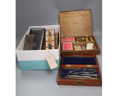 An oak cased games compendium, cased drawing instruments, binoculars, a Tunbridge ware cribbage board, etc.