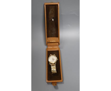 A gentleman's late 1950's 9ct gold Omega manual wind wrist watch, movement c.267, on associated rolled gold bracelet, case di