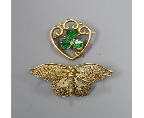 A yellow metal filigree butterfly brooch (tests as 18ct), 5.2g and a 15ct gold, enamel and pearl clover leaf openwork brooch,