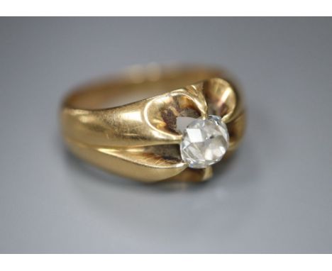 An early 20th century yellow metal and claw set solitaire diamond ring, size N, gross 7.1 grams, the old cut stone weighing a