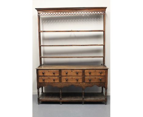 EARLY 19TH CENTURY OAK POTBOARD DRESSER having open three shelf rack with moulded cornice over pierced frieze, the moulded ed