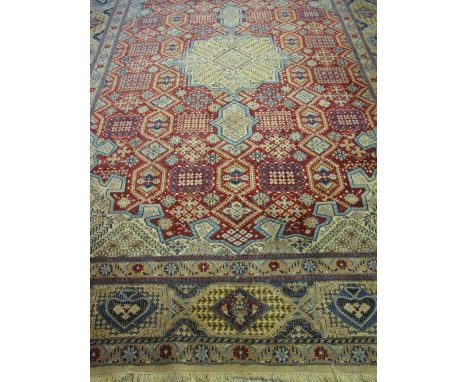 20TH CENTURY ISFAHAN PERSIAN CARPET overall decorated with stylised foliate and geometric designs on a cream, beige and red g