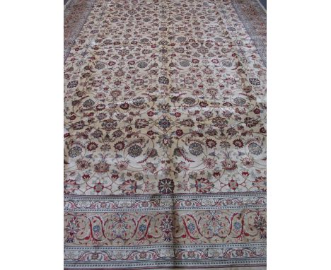 LARGE IVORY GROUND FOLIATE DESIGN KASHMIRI CARPET overall with floral medallions, 400 x 271cm (including fringe).(B.P. 24% in