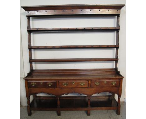 18TH CENTURY WELSH SWANSEA VALLEY POTBOARD DRESSER, having three shelf open rack with moulded cornice and shaped sides on str