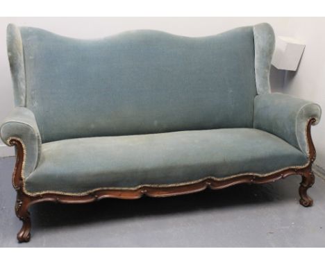 18TH CENTURY DESIGN UPHOLSTERED WING BACKED, THREE SEATER SOFA, having stuff over scroll arms and seat with walnut lower fram