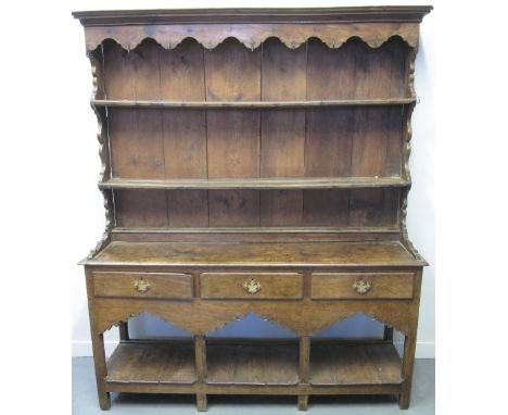 19TH CENTURY OAK TWO STAGE POTBOARD DRESSER, the panelled two shelf rack back above three drawer base, carved frieze raised o